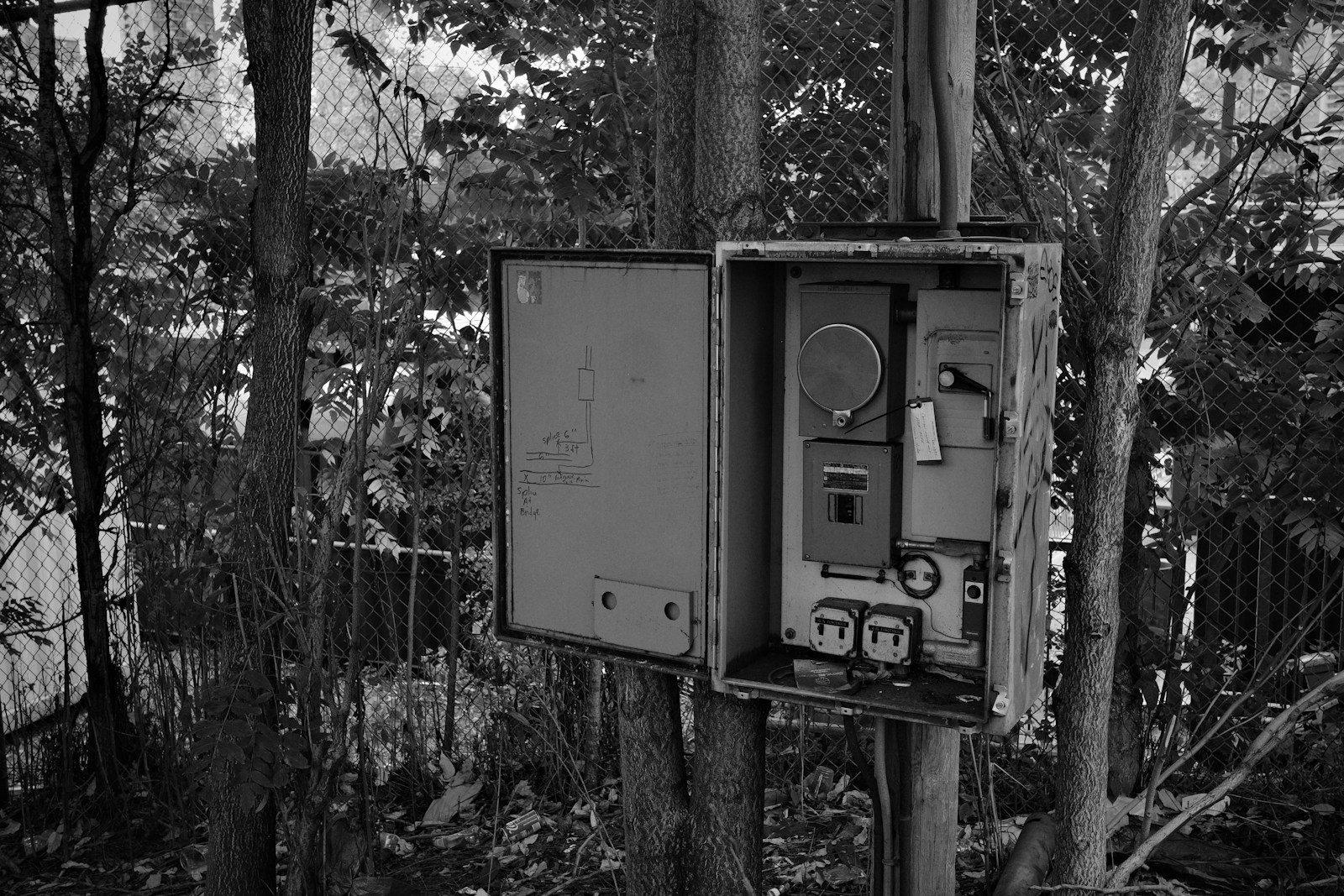 Open electrical box mounted on a pole outdoors